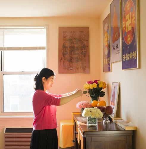 Ванг Хуиџуан му оддава почит на основачот на Фалун Гонг во својата куќа во Квинс, Њујорк, на 8 јануари 2016 година. Со својот сопруг и ќерка, побегнала од Кина во 2014 година и добила азил по повеќе години мачење заради вежбање на Фалун Гонг. (Самира Буау / Епох Тајмс)